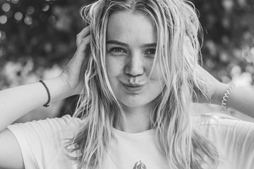 Portrait of a young student girl with blonde hair without makeup.Girl positive smiles. Teenage or student lifestyle 