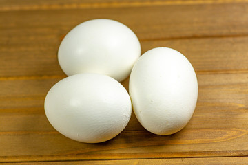 Three eggs on the kitchen table ready for frying