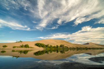 Fototapeta na wymiar Reflection with clouds in a lake at Bruneau Sand Dunes State Park Idaho