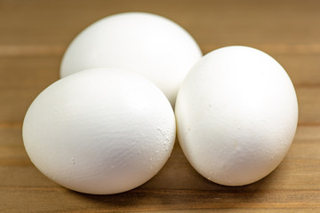 Three eggs on the kitchen table ready for frying