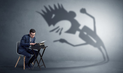 Man working hard and he is afraid of a yelling shadow
