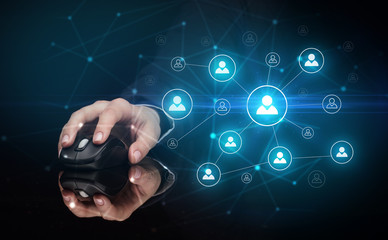 Hand using wireless mouse in a dark environment with human network concept