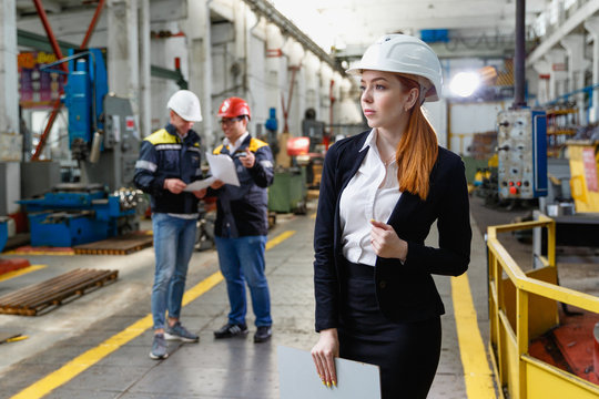 Young Female Engineer Using Clipboard.Female Quality Inspector At Factory