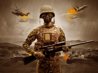 Armed soldier with sniper in the middle of a war
