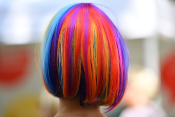 A rainbow colored hairstyle of a woman who visits the lesbian and gay street party in...