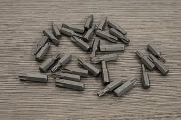 Tools, set steel drill bits on a decorated wood table