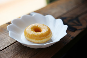 Sugar doughnut (Glazed donut) sweet dessert in white dish unhealthy snack concept.