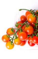 Cherry tomatoes on a branch in transparent retail plastic box