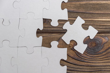 Business concept image for completing the final puzzle piece. wooden background. Cooperation,...