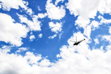 Fototapeta na wymiar helicopter flying in a cloudy sky