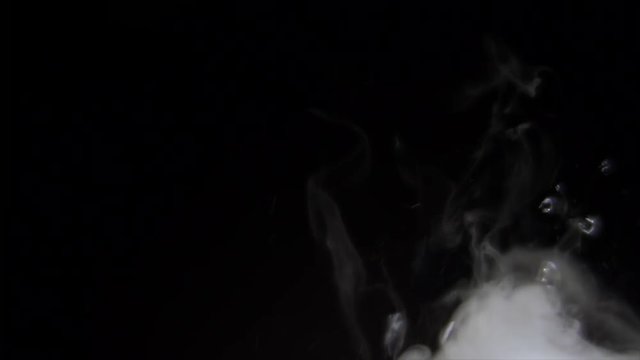 BUBBLING MIST WITH NEGATIVE SPACE IN LEFT FRAME.  SLOW MOTION.