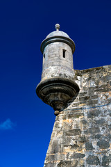 Fototapeta na wymiar Watchtower in the iconic Spanish fortress of El Morro guarding the harbor entrance of San Juan, Puerto Rico
