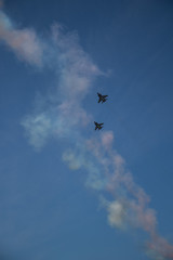 Military airplanes lined up in a row during the Russian military parade on bright blue sky with clouds in spring