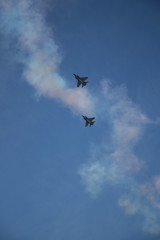 Military airplanes lined up in a row during the Russian military parade on bright blue sky with clouds in spring