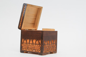 open the beautiful old wooden box with engraving. isolated on white background.