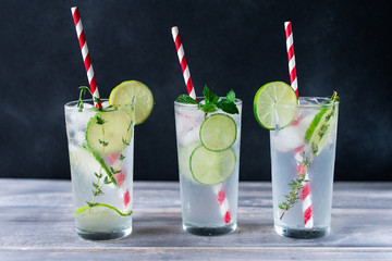 Florence / Tuscany, Italy. - July 21, 2018. alcoholic citrus cocktail with lime, ice, gin, mint and rosemary in bar in Florence. a glass on  a wooden table on a dark background, copy space