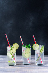 Florence / Tuscany, Italy. - July 21, 2018. alcoholic citrus cocktail with lime, ice, gin, mint and rosemary in bar in Florence. a glass on  a wooden table on a dark background, copy space
