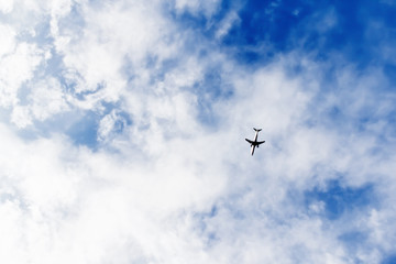 Fototapeta na wymiar airplane flying in a cloudy sky