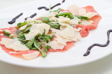 Beef carpaccio with parmesan, rocket and balsamic vinegar