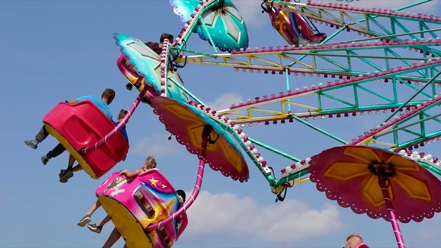amusement park chair carousel rotating against blue sky