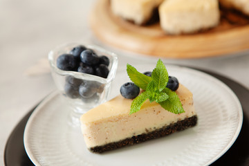 Classic New York cheesecake with fresh berries on white plate