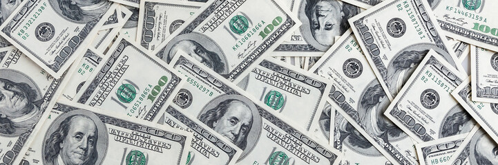 A pile of one hundred US banknotes. Cash of hundred dollar bills, dollar background image. - obrazy, fototapety, plakaty