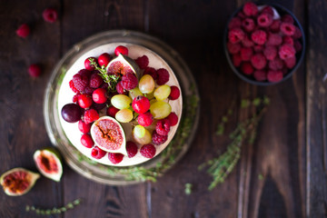 Delicious chocolate cake with figs and berries on a rustic background. Wedding Naked cake with fruits in rustic style.