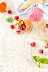 Summer sweet berries and desserts, various of ice cream flavor in cones pink (raspberry), vanilla and chocolate with mint on light concrete background copy space