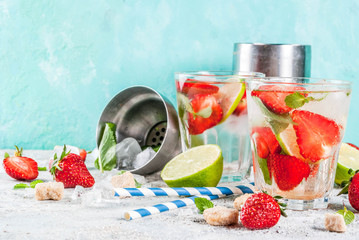 Summer refreshment drink, strawberry mojito cocktail on light concrete background, copy space