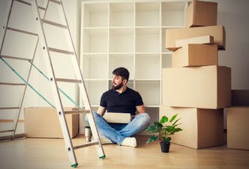 Happy young man moving to new home - having fun
