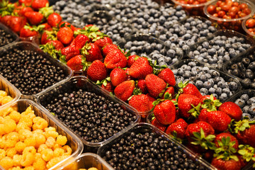 Colourful mix of different fresh berries at market