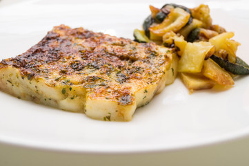fried fish in the plate with vegetable