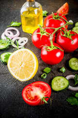 Cooking background, fresh salad ingredients, italian cuisine - tomatoes, olive oil, lemon, cucumbers, arugula, parsley, onions, Dark rusty background copy space