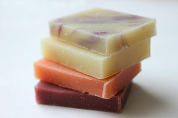 Natural handmade soap stacked piles close-up on a white background