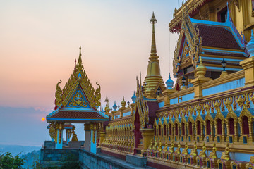 Fototapeta premium scenery sunrise above the golden pagoda on the high mountain in Kiriwong temple in Nakornsawan Thailand