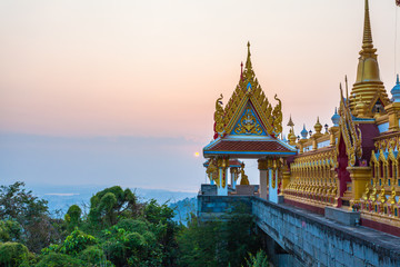 scenery sunrise above the golden pagoda on the high mountain in Kiriwong temple in Nakornsawan Thailand