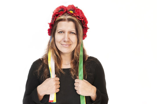 Beautiful woman with a wreath on her head on a white background. She celebrates Independence Day of Ukraine
