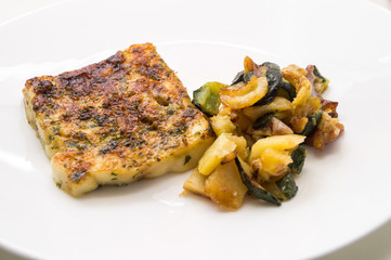 fried fish in the plate with vegetable