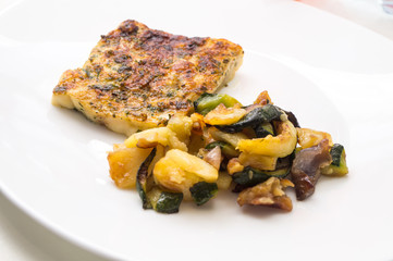 fried fish in the plate with vegetable