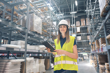 Beautiful young woman worker of furniture store in shopping center. Girl looking for goods with a...
