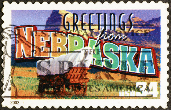 Greetings from Nebraska postcard on postage stamp