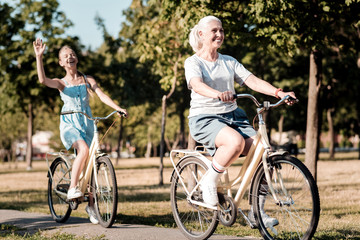 Naklejka premium My granny. Attractive woman expressing positivity and looking forward while moving pedals