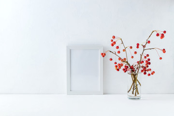 Mockup white frame and branches with small red apples
