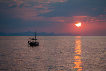 Fototapeta na wymiar Fishing boat on the sunrise in the sea