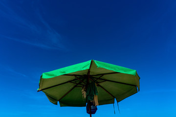Green umbrella under the blue sky