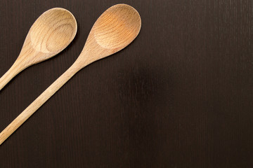 Wooden spoons on black table