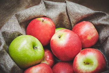 Selective forcus, close-up of red apples in basket, Sackcloth texture background