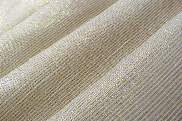 shiny fabric close-up of the folds on the material structure of the fibers of the recolonies of the...