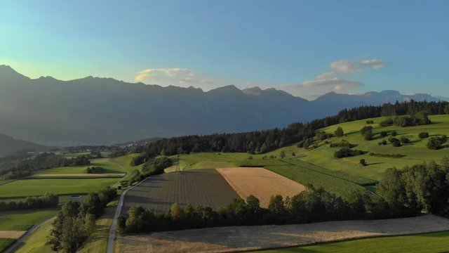 Arial Shot Tirol Mountains fields sunny summer day