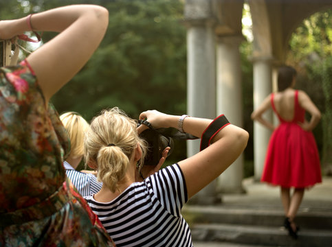 group of young student photographer taking pictures on photography shooting workshop course outdoor